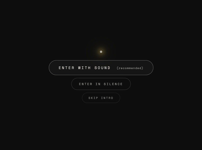 The 2026 memorial opening on near black: one small warm light with a soft halo, and three rounded buttons beneath it.
