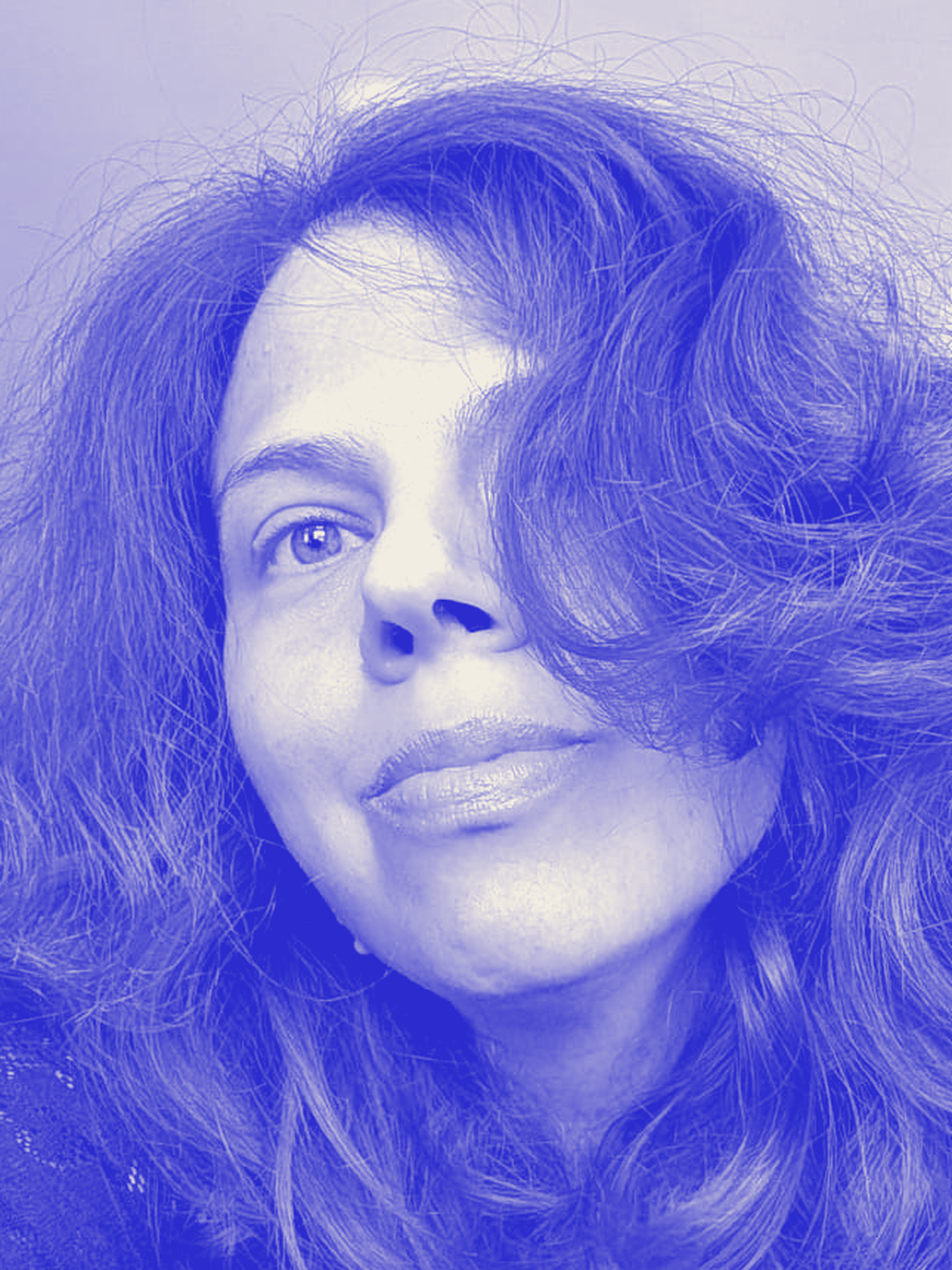 Hagara, a self-portrait graded into the site's ultramarine, her hair filling the frame.